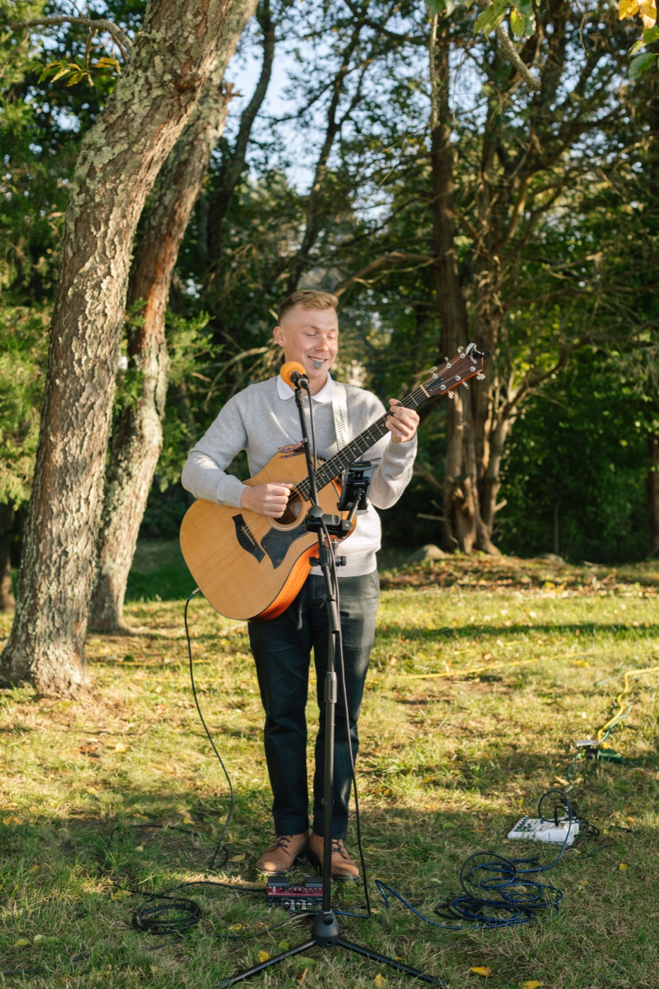 Shawn Chasten performing an acoustic set outdoors