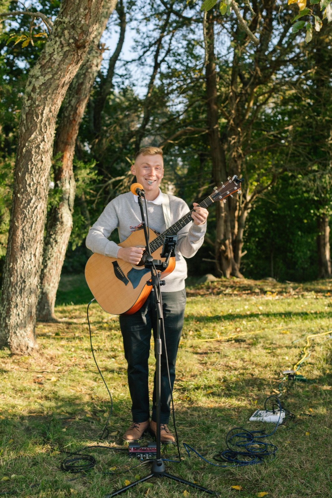 Shawn Chasten playing guitar outdoors in daylight
